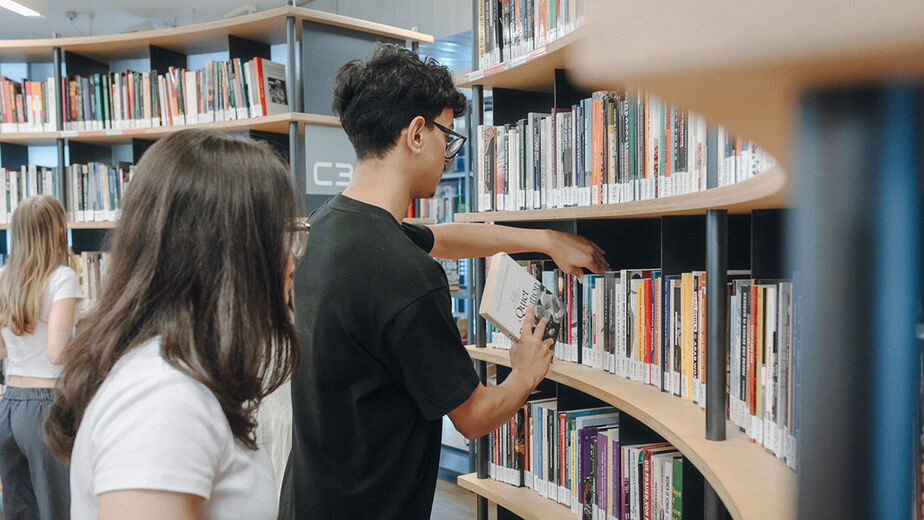 Schüler*innen in der C3-Bibliothek Schüler*innen in der C3-Bibliothek, vor einem Bücherregal